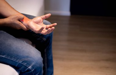 Bilek yaralanması, tıbbi tedavi, ilk yardım, sağlık ve tıbbi konsept nedeniyle bileğini kapatan adam.