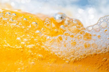 Parlak portakal yağını veya birayı kapat doku ve doğa dalgaları, güzel dalgalar eğrisi ve grafik tasarım ve arka plan için pürüzsüz küçük kabarcıklar, yağlı baloncuklar, yumuşak bira kabarcıkları, seçici odaklanma