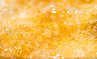Parlak portakal yağını veya birayı kapat doku ve doğa dalgaları, güzel dalgalar eğrisi ve grafik tasarım ve arka plan için pürüzsüz küçük kabarcıklar, yağlı baloncuklar, yumuşak bira kabarcıkları, seçici odaklanma
