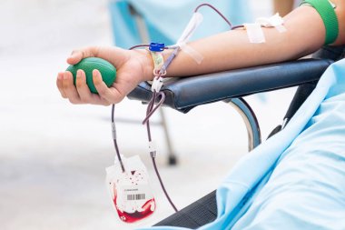 Klinikte kan bağışı yapan birinin yakın çekimi. Fedakarlığı, tıbbi bakımı ve hayat kurtaran bağışı sembolize eden bir sağlık hizmeti kavramı