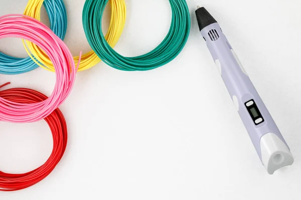 stock image Top view on 3d pen, kit of colourful PLA or ABS plastic filament on white background. Closeup