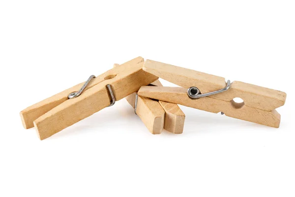 stock image Three wooden clothespins, isolated on a white background, lie together. Close up photo. Full depth of field.