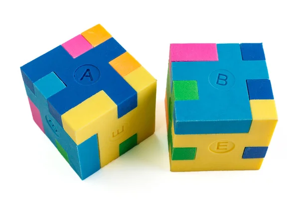 Two cube puzzle of multi-colored rubber shapes. Concept of decision making process, creative, logical thinking. Logical tasks. Conundrum, find the missing piece of the proposed.