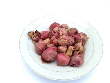 fresh shallots in a white plate