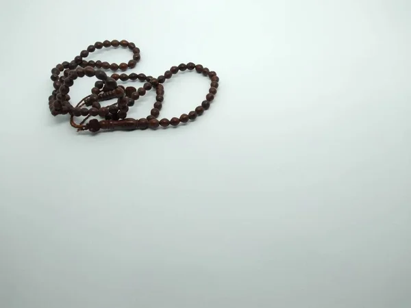 black prayer beads on a white background