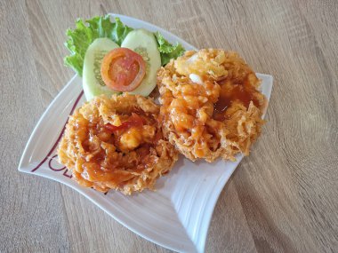 Surabaya-October 28, 2023: Photo of one of the food in a solaria restaurant called fu yung hai. Typical Chinese dishes made from eggs, shrimp, and vegetables are then fried and served with sauce.