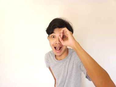 Beyaz arka planda izole edilmiş gri tişörtlü komik bir Asyalı.