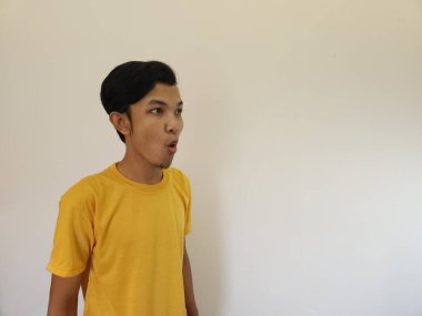 Funny amazing shocked surprised asian man face advertise isolated on white