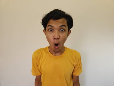 Funny shocked surprised closeup asian face man isolated on white background