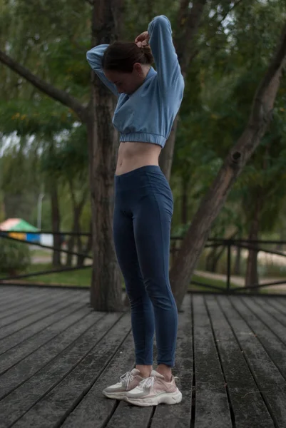 Widok Młodą Dziewczynę Sportowym Ciałem Robi Ćwiczenia Akrobatyczne Pochmurną Deszczową — Zdjęcie stockowe