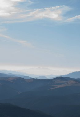 Sonbaharda güneşli bir günde mavi gökyüzünün altındaki dağların manzarası