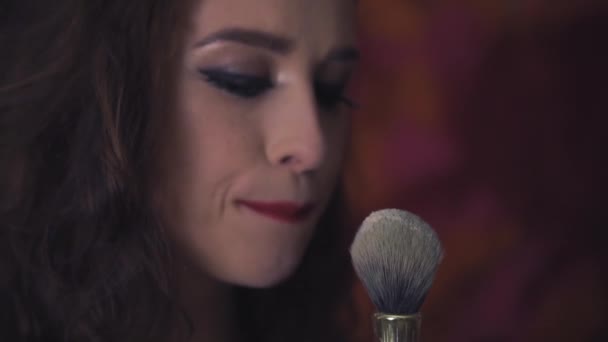 Beautiful White Woman Face Close Slow Motion Blows Cosmetic Brush — Stock Video