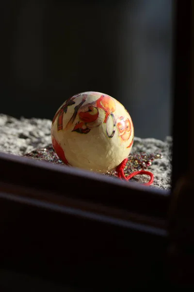 stock image White Christmas decoration on the side of a window lighted by the sun 