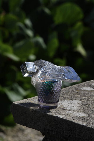 water fountain. stone with a green background.