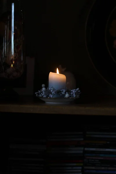 candle in a dark room with a burning candles