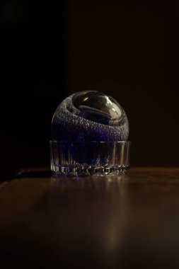 a close-up of three colored shaving water on a black background