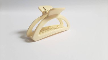 Single or One Cream or Milk White Hair Clip on isolated white background. Simple Elegant Plastic Hairpin Hair Grip Hair Claw or Hair Crab Accessories.