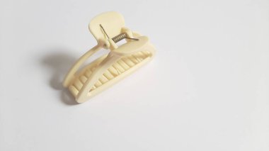 Single or One Cream or Milk White Hair Clip on isolated white background. Simple Elegant Plastic Hairpin Hair Grip Hair Claw or Hair Crab Accessories.