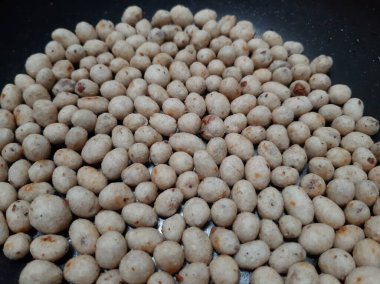 White and brown round nuts and flour snack texture a.k.a. sukro. Indonesian traditional snack made from tapioca flour and nut inside.