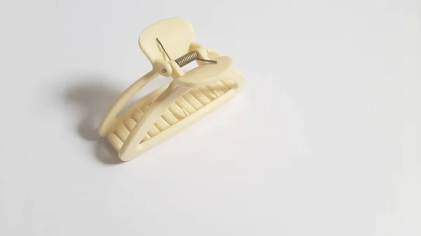 Single or One Cream or Milk White Hair Clip on isolated white background. Simple Elegant Plastic Hairpin Hair Grip Hair Claw or Hair Crab Accessories.