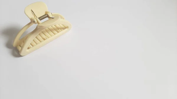 Single or One Cream or Milk White Hair Clip on isolated white background. Simple Elegant Plastic Hairpin Hair Grip Hair Claw or Hair Crab Accessories.