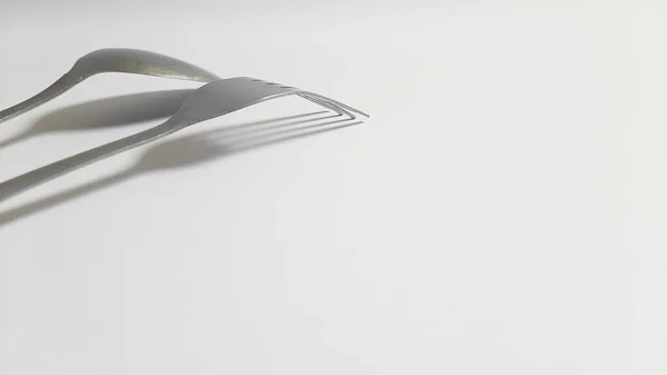 Metal or steel silver spoon and fork on isolated white background