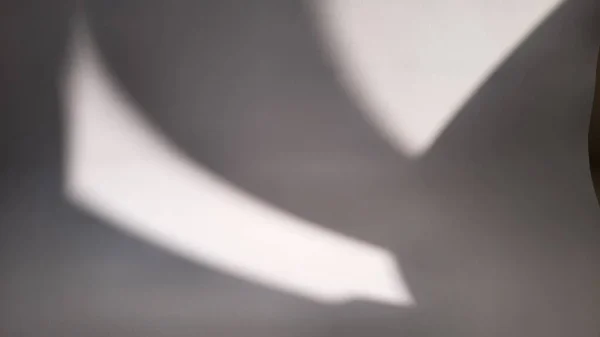 Blurred abstract grey or gray background with sunlight