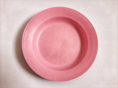 Top view empty plastic pink plate on isolated white background
