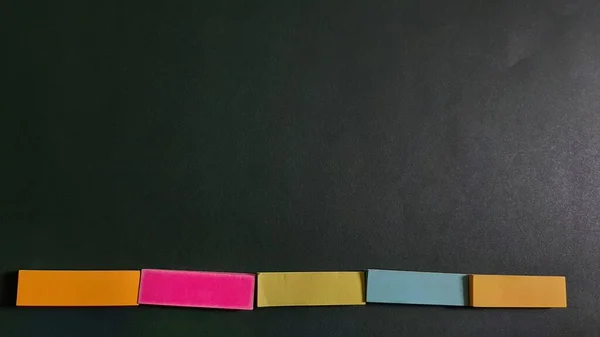 Pastel and Neon Sticky Notes or Paper Index or Page Marker or Flags Tabs or Note Adhesive Post Highlighter or Memo Pads for Highlighting Documents on Isolated Dark Background