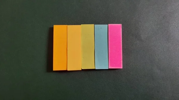 Pastel and Neon Sticky Notes or Paper Index or Page Marker or Flags Tabs or Note Adhesive Post Highlighter or Memo Pads for Highlighting Documents on Isolated Dark Background