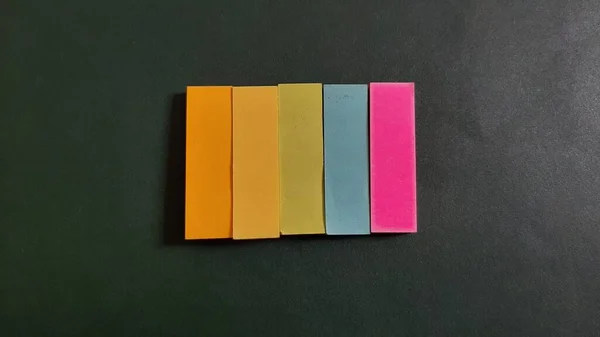 Pastel and Neon Sticky Notes or Paper Index or Page Marker or Flags Tabs or Note Adhesive Post Highlighter or Memo Pads for Highlighting Documents on Isolated Dark Background