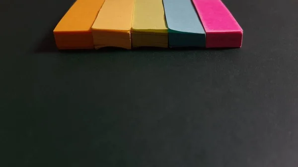 Pastel and Neon Sticky Notes or Paper Index or Page Marker or Flags Tabs or Note Adhesive Post Highlighter or Memo Pads for Highlighting Documents on Isolated Dark Background