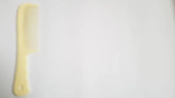Blurred or unfocused or defocused white milk single or one comb on isolated white background