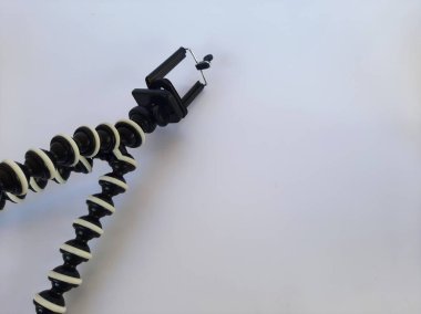 Octopus tripod or gorilla pod on isolated white background. Flexible folding tripod for mobile phones.