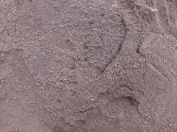 Pile of dark sand or soil for construction
