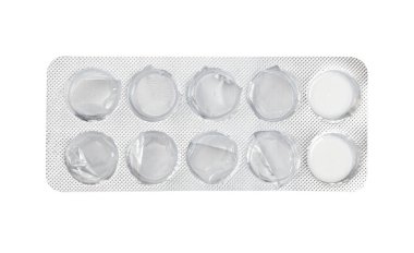 Empty silver blister with two medical pills left, isolated on white background. Used tablets, drugs, capsules, used antibiotic packaging. Clipping path, close up