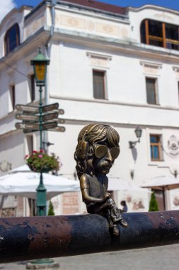 mini figurine of the keyboardist of the group Deep Purple John Lord. He is completely sad in glasses and headphones, turned his back to Corzo Street. Sculptor Mikhail Kolodko. 25.06.22 Ukraine