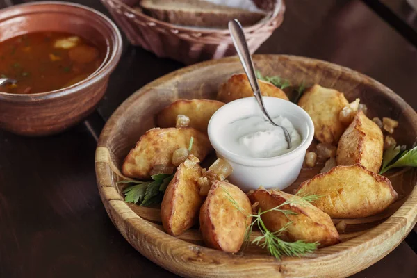 Traditional Ukrainian dish - fried pies with sour cream. Carpathian cuisine. Dishes of Western Ukraine.