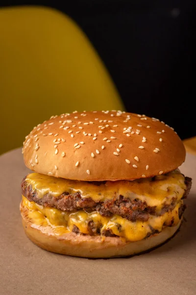double burger with cheese on baking paper.