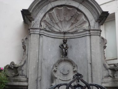Manneken Pis is a landmark 55.5 cm (21.9 in) bronze fountain sculpture in central Brussels, Belgium