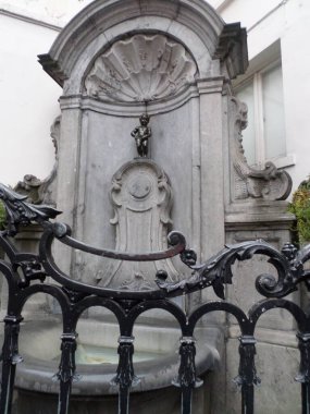 Manneken Pis is a landmark 55.5 cm (21.9 in) bronze fountain sculpture in central Brussels, Belgium