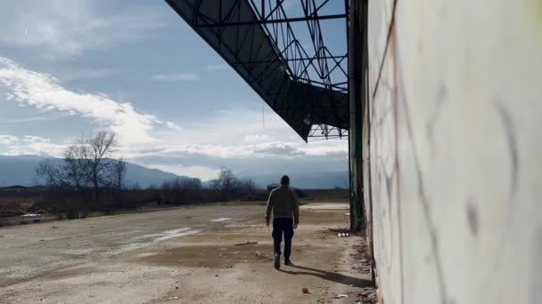 Person Walking Abandoned Factory Loading Area — Stock videók