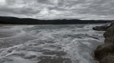 Dark Stormy Waves Crashing On Dark Rocks 