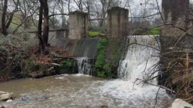 Water Flowing From Old Abandoned Dam Winter Gloomy Day 