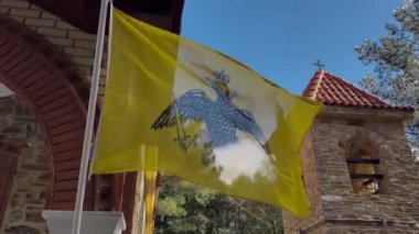 Greek Orthodox Flag Flying In The Wind. Yellow, With The Double Headed Eagle, Churchyard 2, High Church Tower 