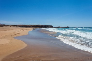 Mavi gökyüzü ve beyaz kumla güzel bir sahil