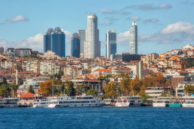 Istanbul, Turkey - October 9th, 2019: View to the shore of Bosforus strait on an early autumn day. Residential buildings and skyscrapers along the shore.
