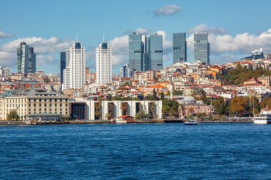 View to the shore of Bosforus strait on an early autumn day. Residential buildings and skyscrapers along the shore.