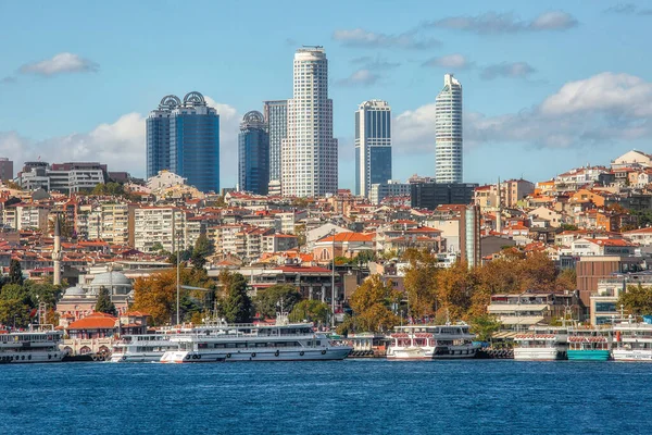Istanbul, Turkey - October 9th, 2019: View to the shore of Bosforus strait on an early autumn day. Residential buildings and skyscrapers along the shore.