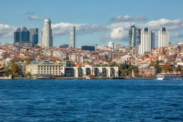 View to the shore of Bosforus strait on an early autumn day. Residential buildings and skyscrapers along the shore.